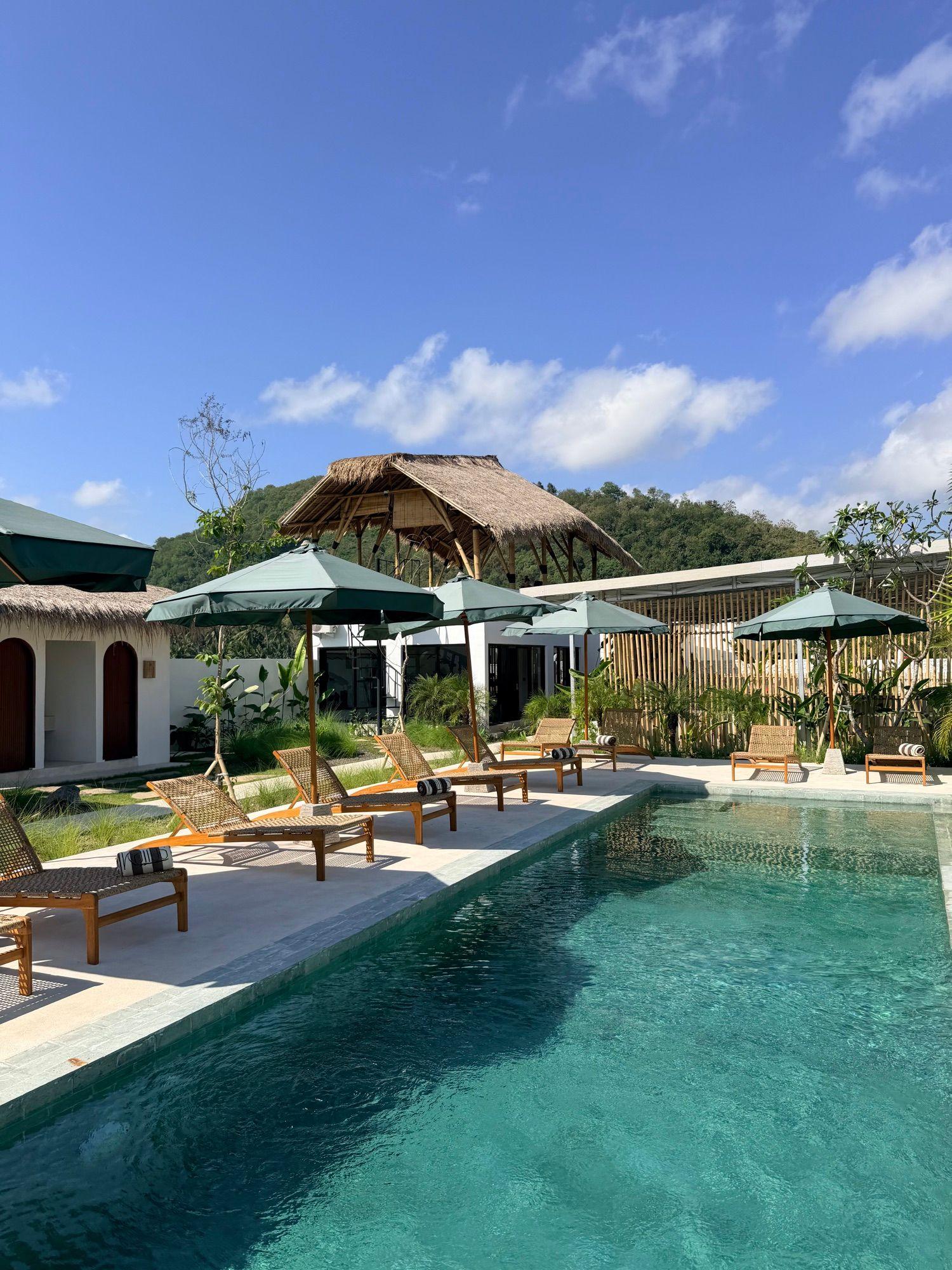 Swimming pool and sun loungers at Kairos Boutique Sports Hotel Lombok in Selong Belanak