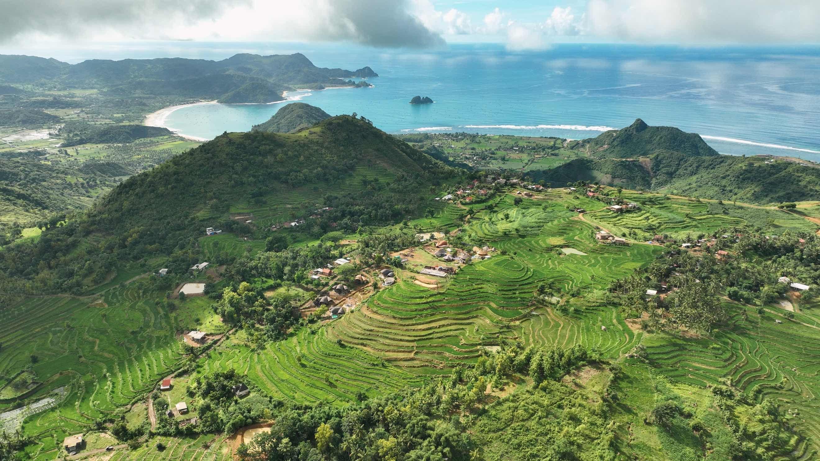 Aerial view of Mandala Eco-Resort on the terraced hillside above Selong Belanak bay