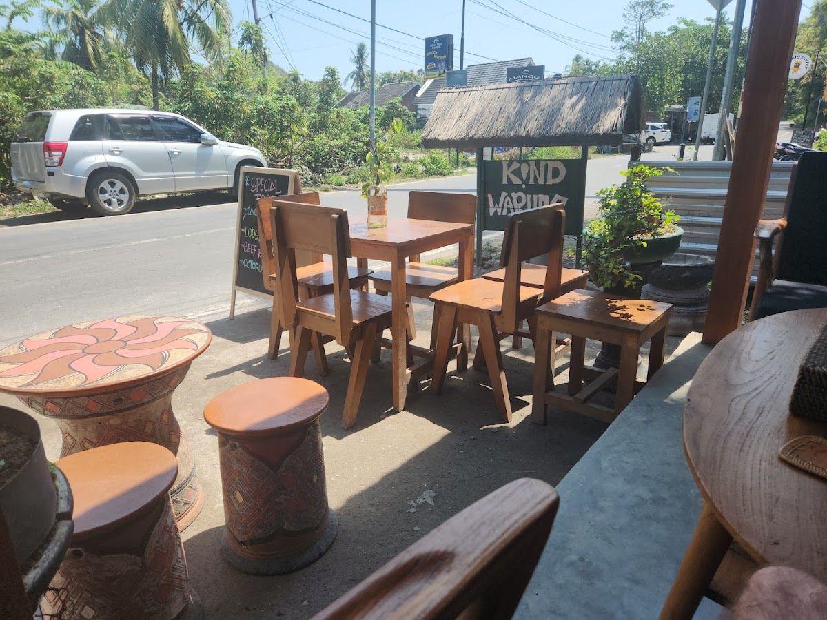 Roadside seating and the Kind Warung sign in Selong Belanak