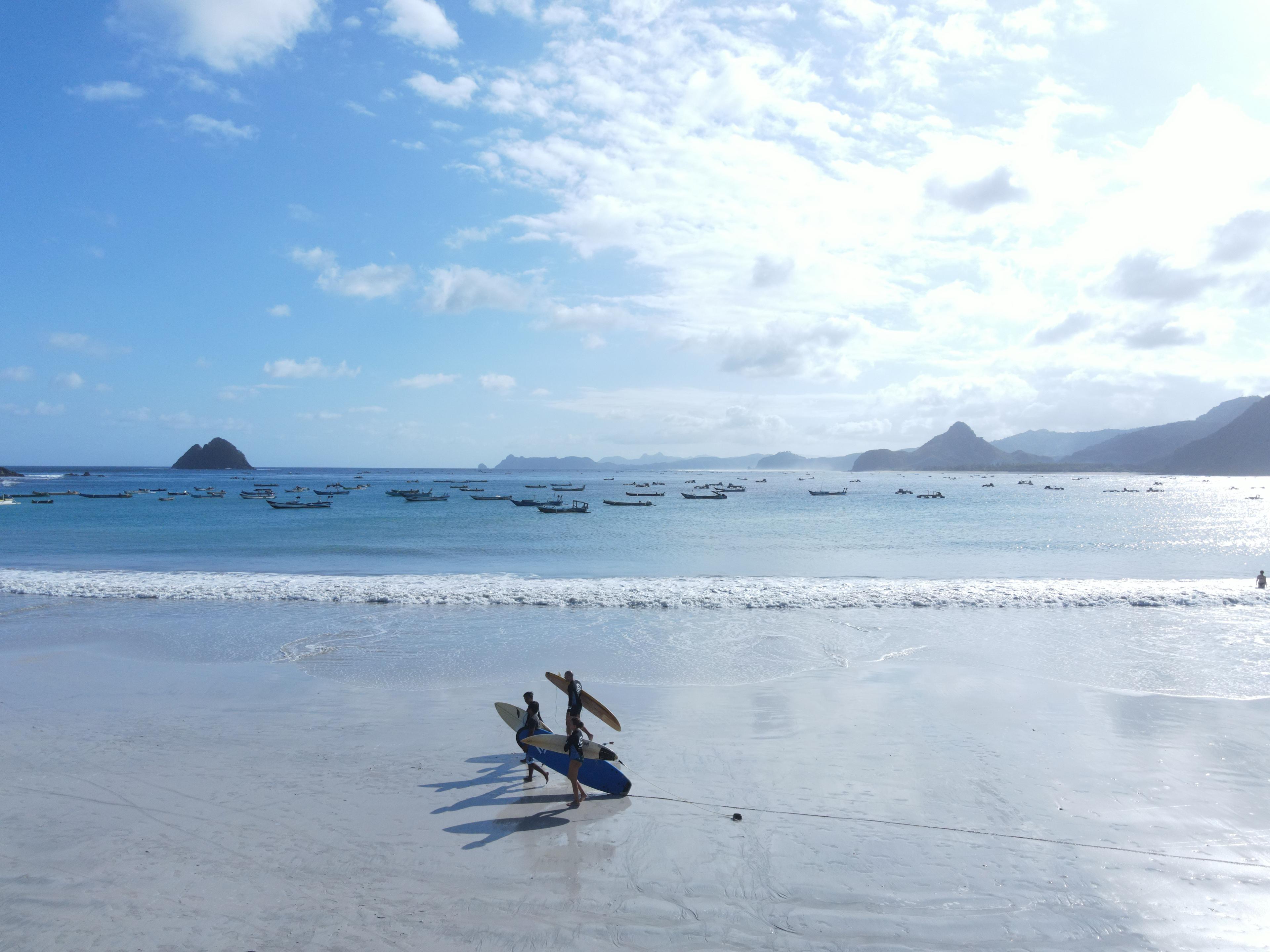 The broad crescent of Selong Belanak Beach backed by green hills