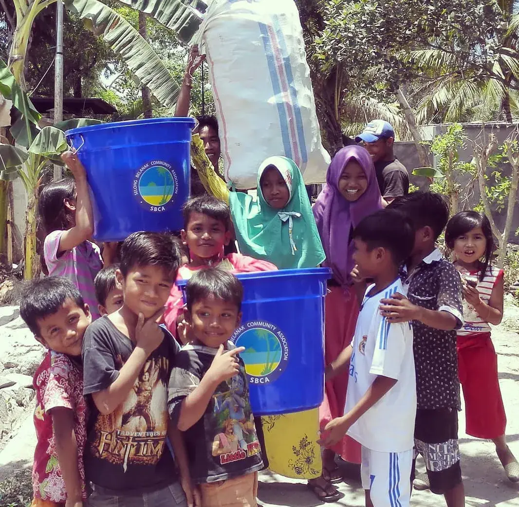 Local children participating in an SBCA community clean-up and bin programme