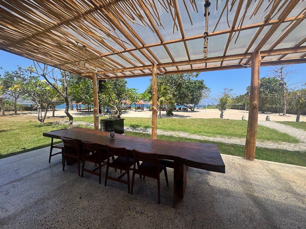 Open-air dining tables overlooking Serangan Beach at Nine Dining