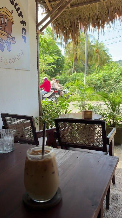 Iced coffee on the shaded terrace at Naughty Surfer Coffee & Eatery