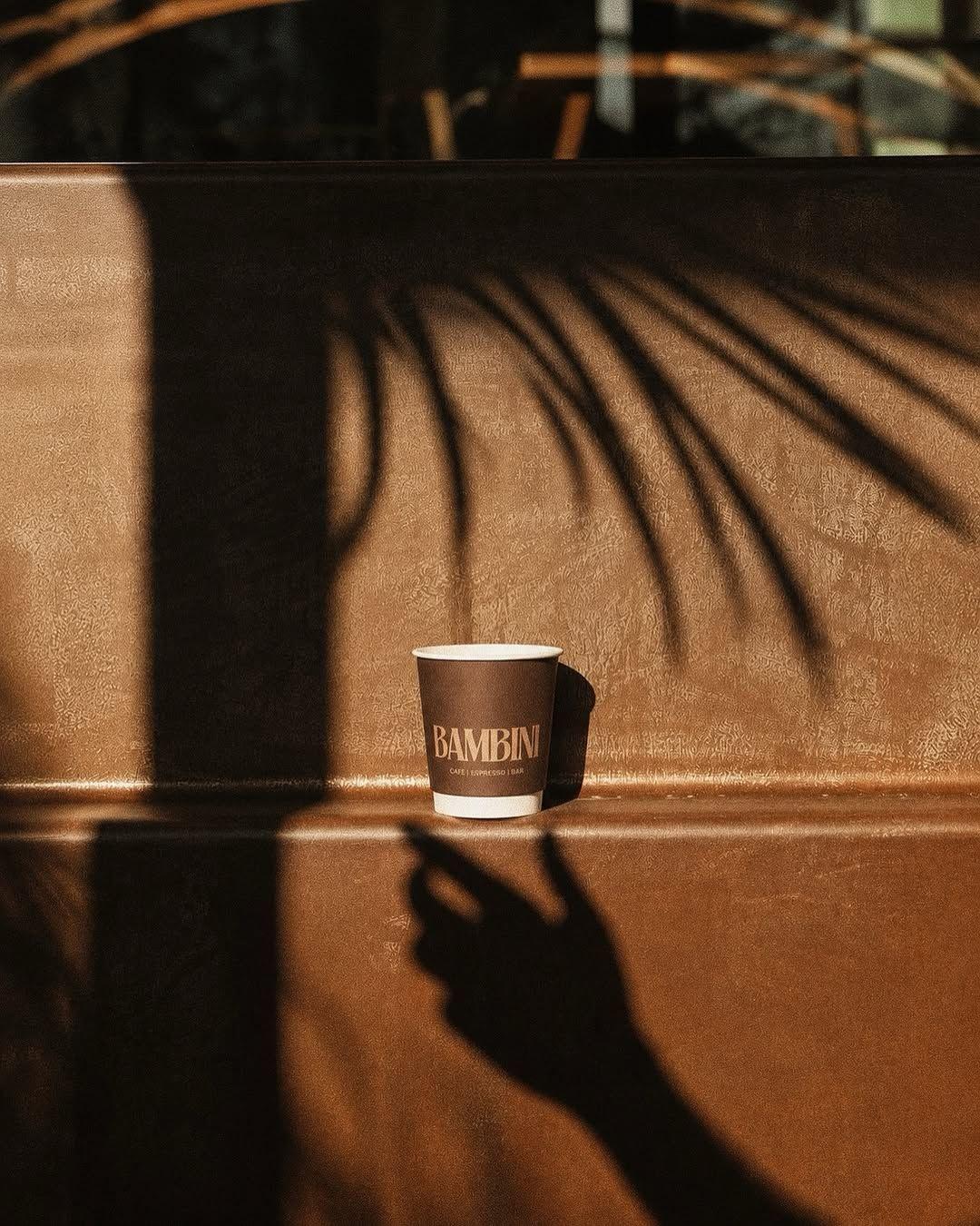 A branded coffee cup inside Bambini Espresso in Selong Belanak