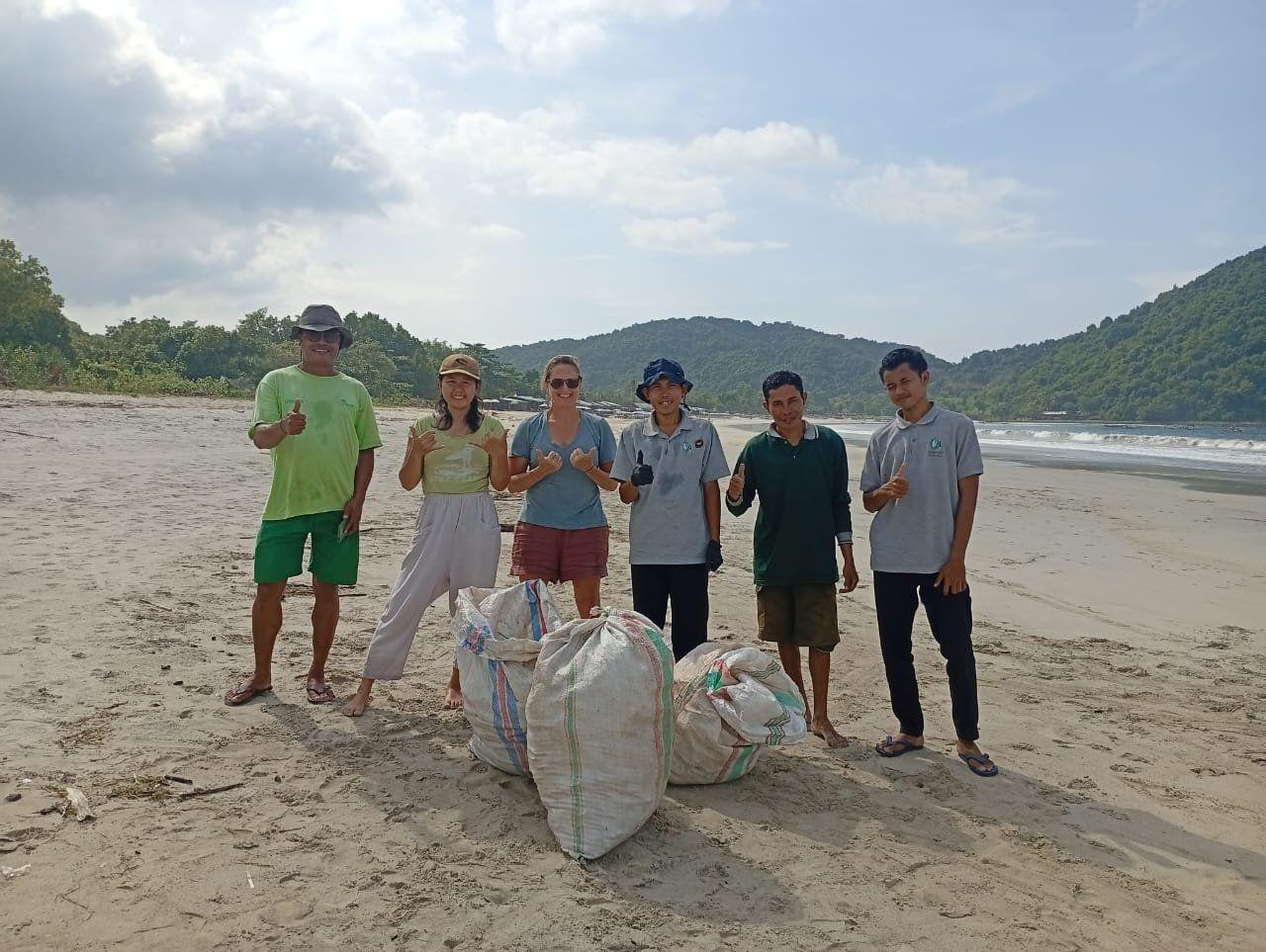 SBCA volunteers with bags collected during a Selong Belanak beach clean-up