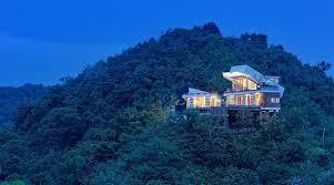 Seven Havens Residence hilltop villa lit at dusk above the jungle, Selong Belanak, Lombok